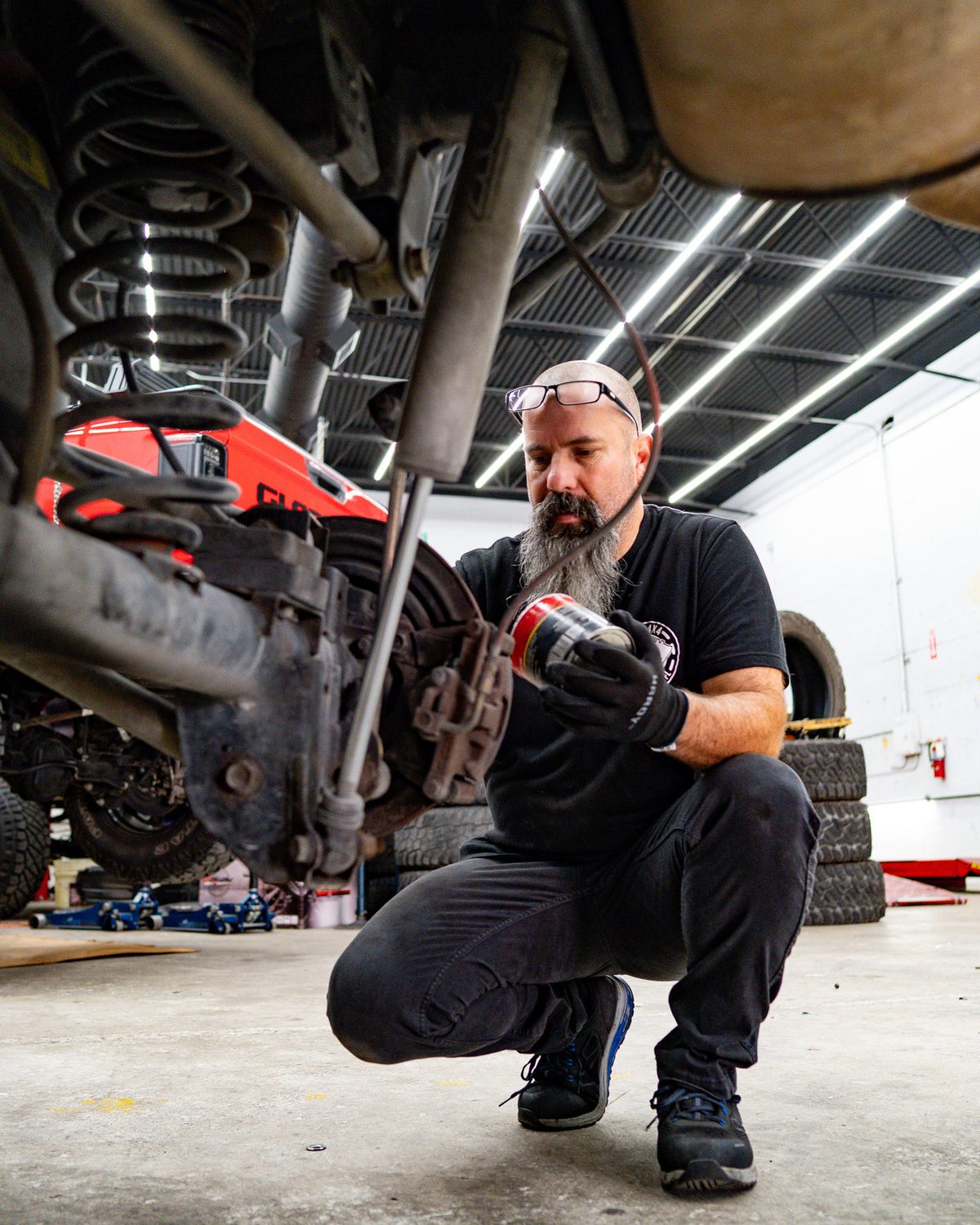 Suspension work underneath a lifted truck